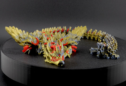 Model dragon sculpture on a black stand with a dark background