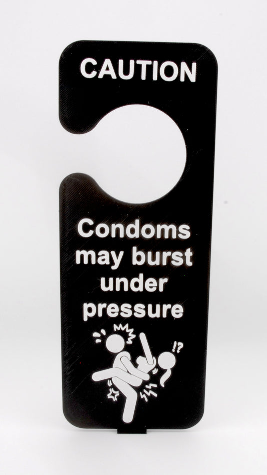 Funny Adult Door Hanger – “Caution: Condoms May Burst Under Pressure” Naughty Gag Sign
