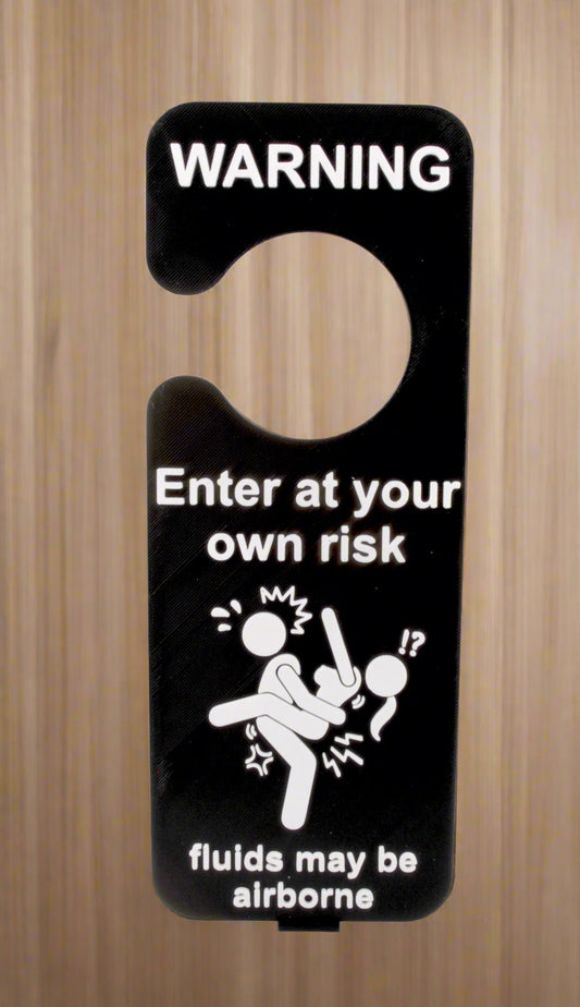 Black and white warning sign with humorous text and icon on a white background