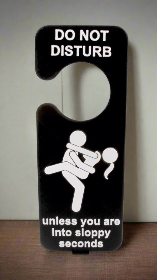 Door hanger with 'Do Not Disturb' sign and humorous illustration on a white background