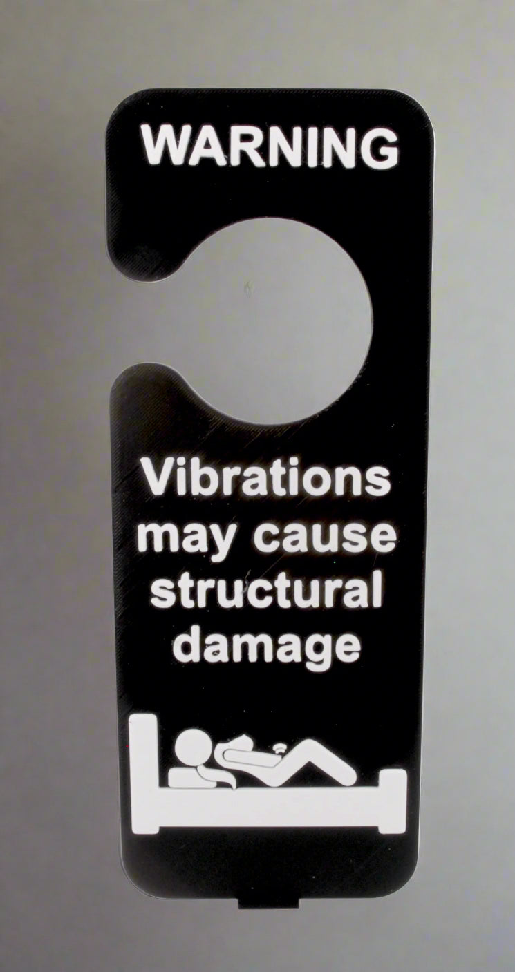 Door hanger with warning text about vibrations causing structural damage on a white background