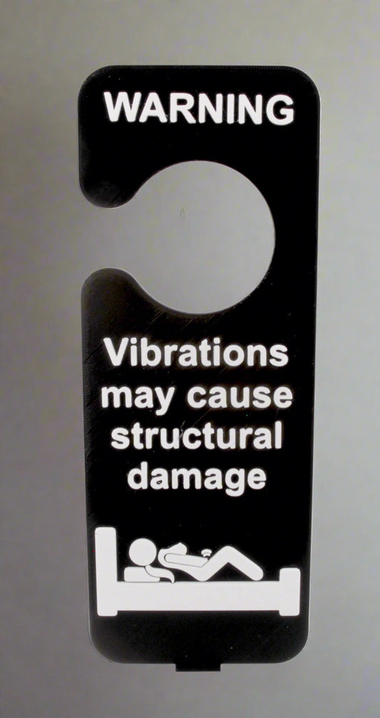 Door hanger with warning text about vibrations causing structural damage on a white background