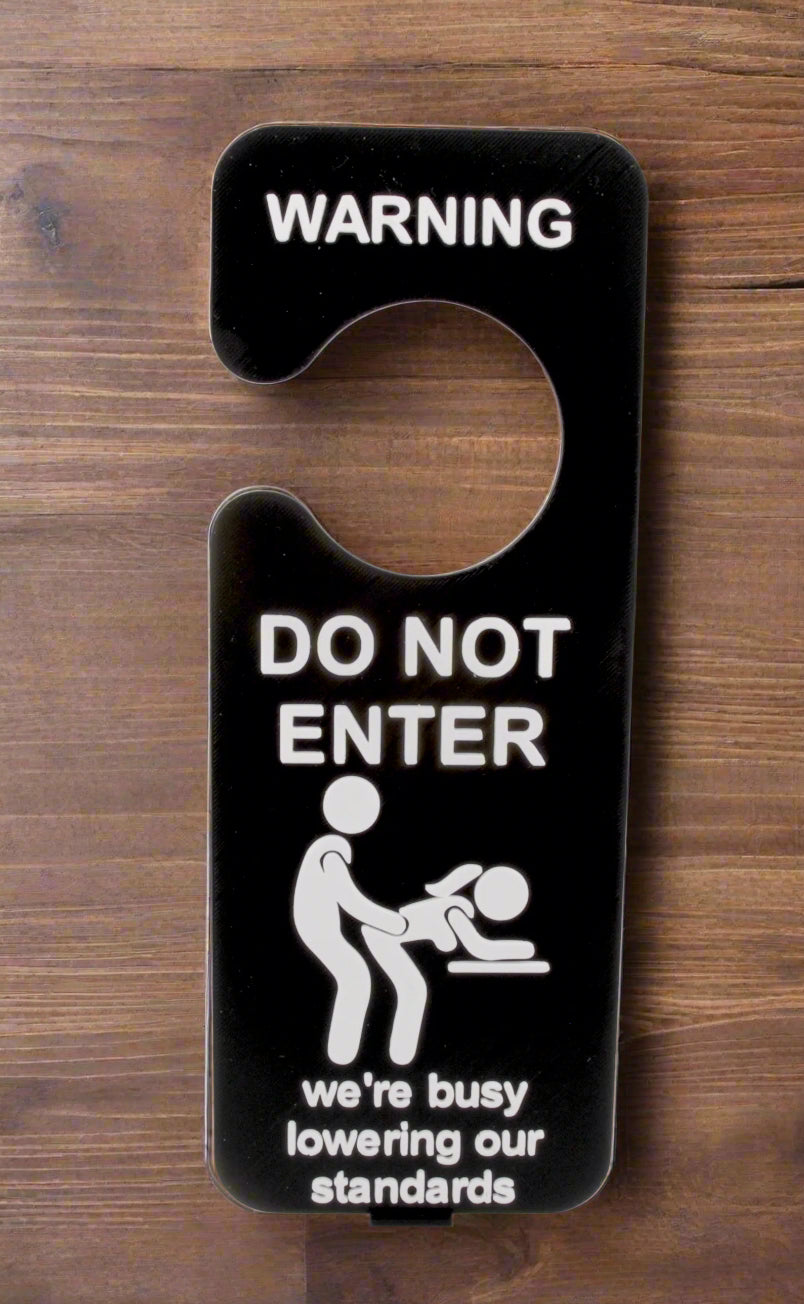 Door hanger with 'Do Not Enter' and humorous message on a white background