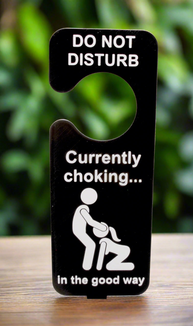 Door sign with humorous message about choking in the good way